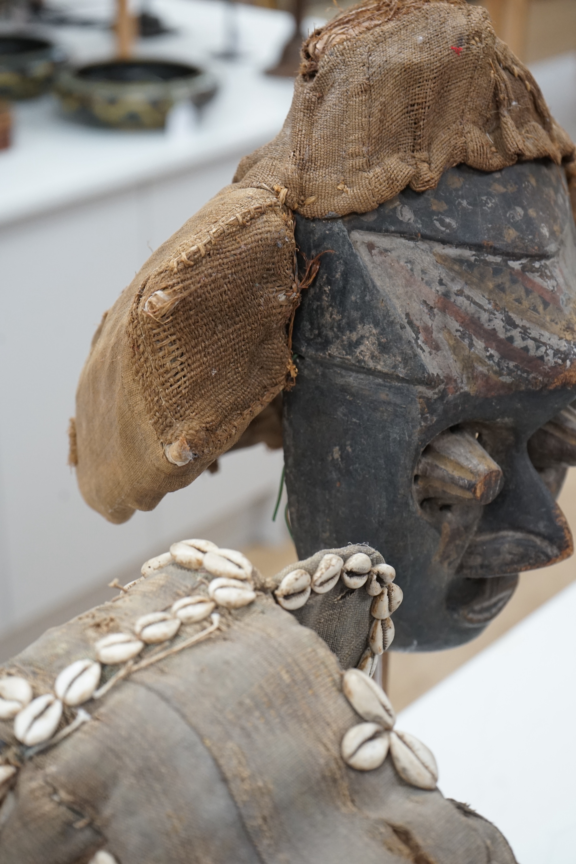 An African Ivory Coast/Liberian Dan mask together with another from the Democratic Republic Congo, both on stands, tallest 58cm including stand. Condition - some damage to the fabric of hats